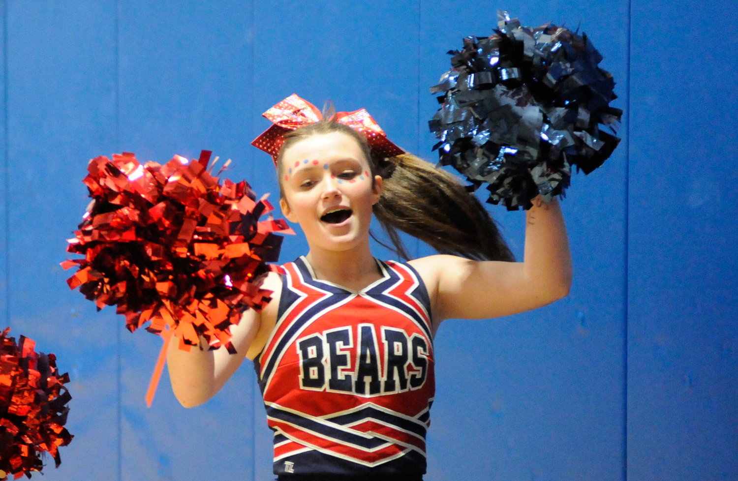 Cheerleader spirit. Tri-Valley’s Grace Deyo strikes a pose with her poms as the cheerleaders return from the half.